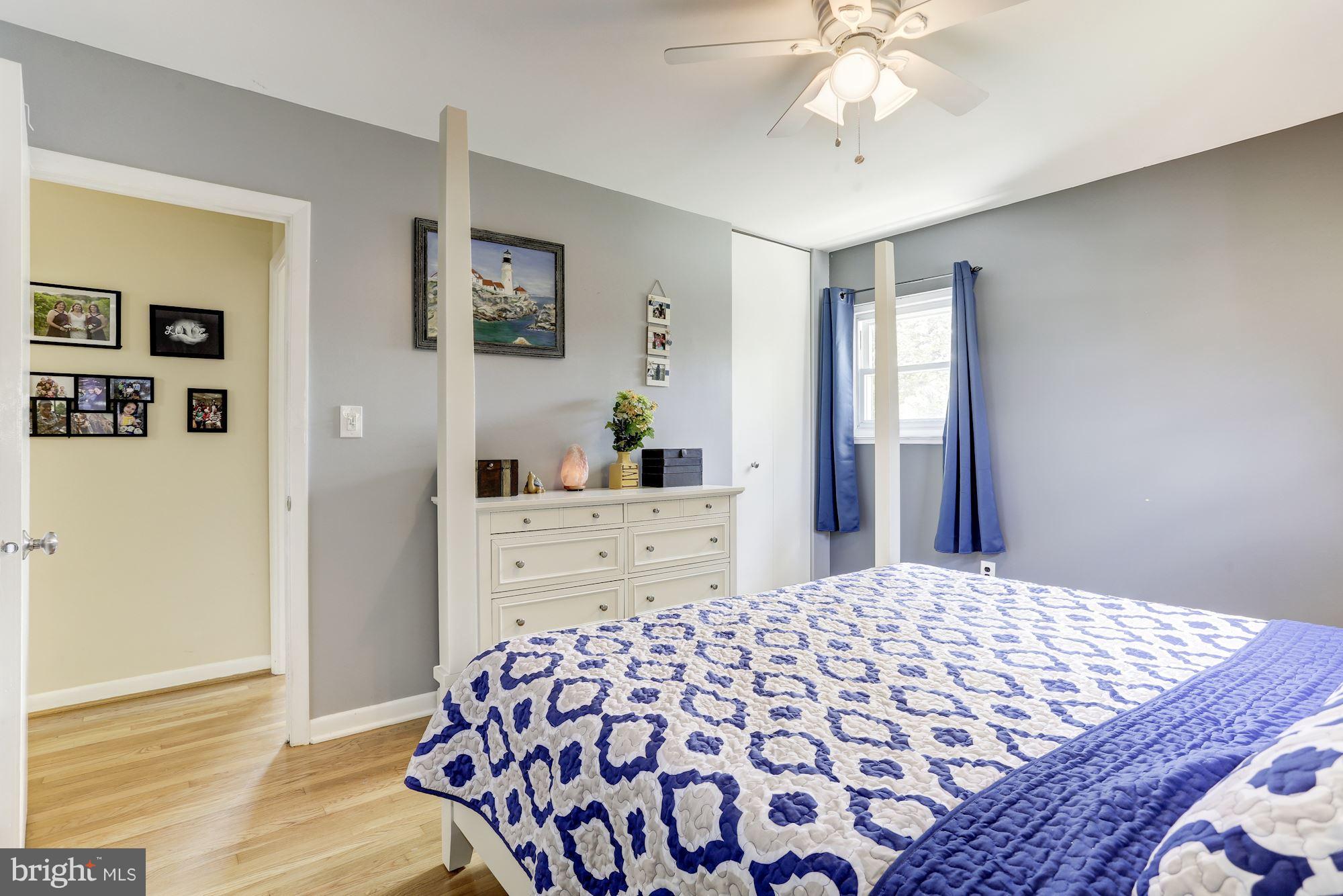 6134 Wheatland Road Baltimore, MD 21228 - Photo 15 of 30 a bedroom with a bed and wooden floor