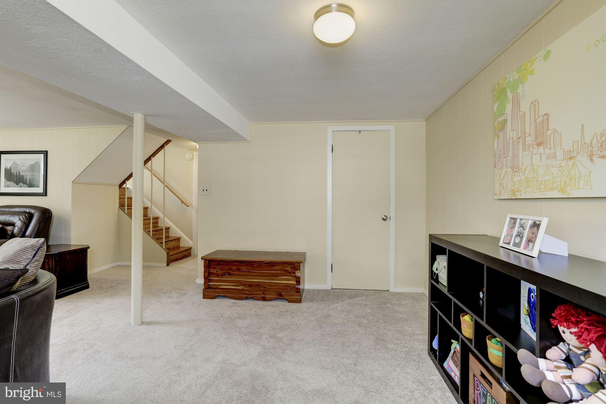 6134 Wheatland Road Baltimore, MD 21228 - Photo 22 of 30 a living room with furniture and a flat screen tv