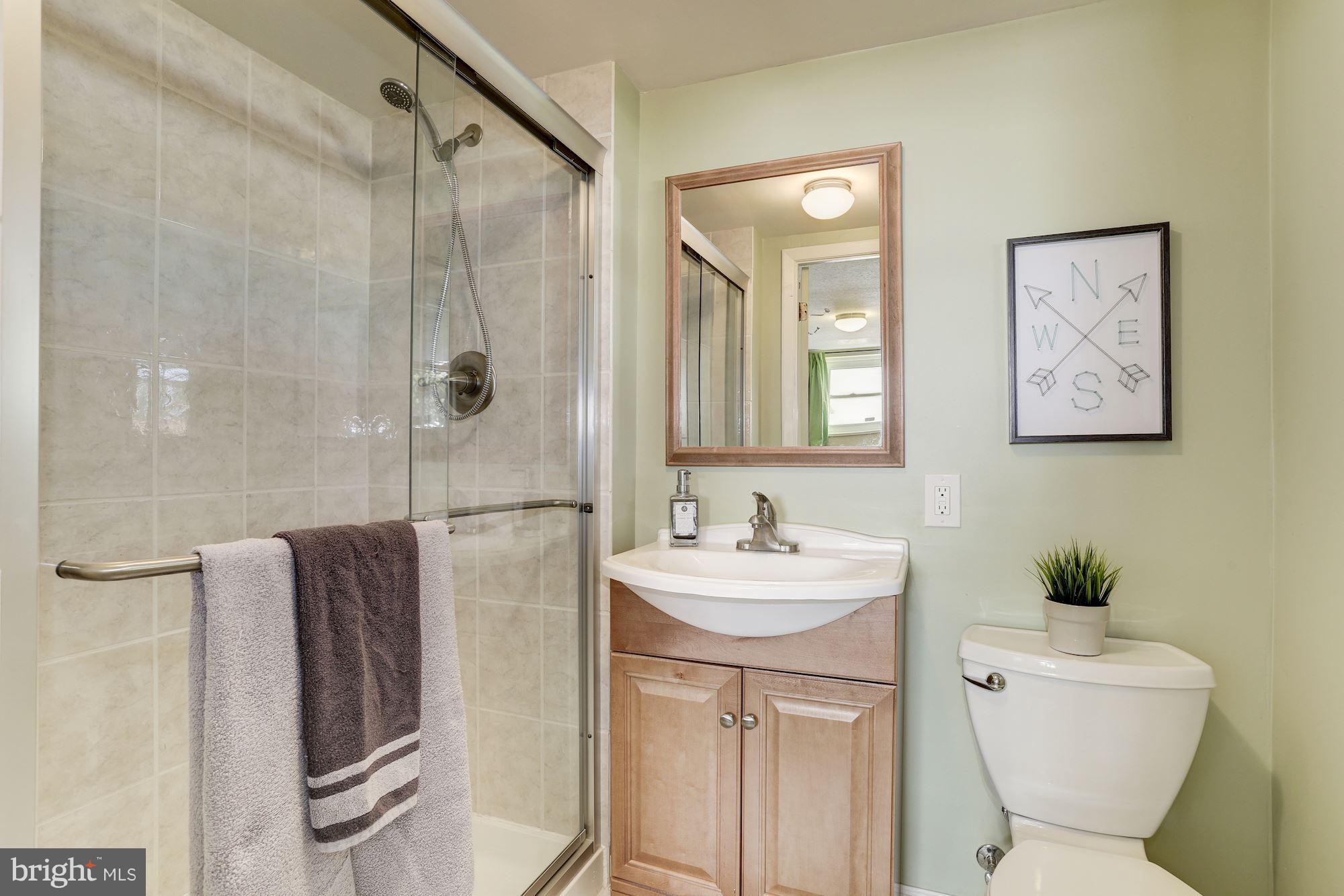 6134 Wheatland Road Baltimore, MD 21228 - Photo 23 of 30 a bathroom with a toilet sink and shower