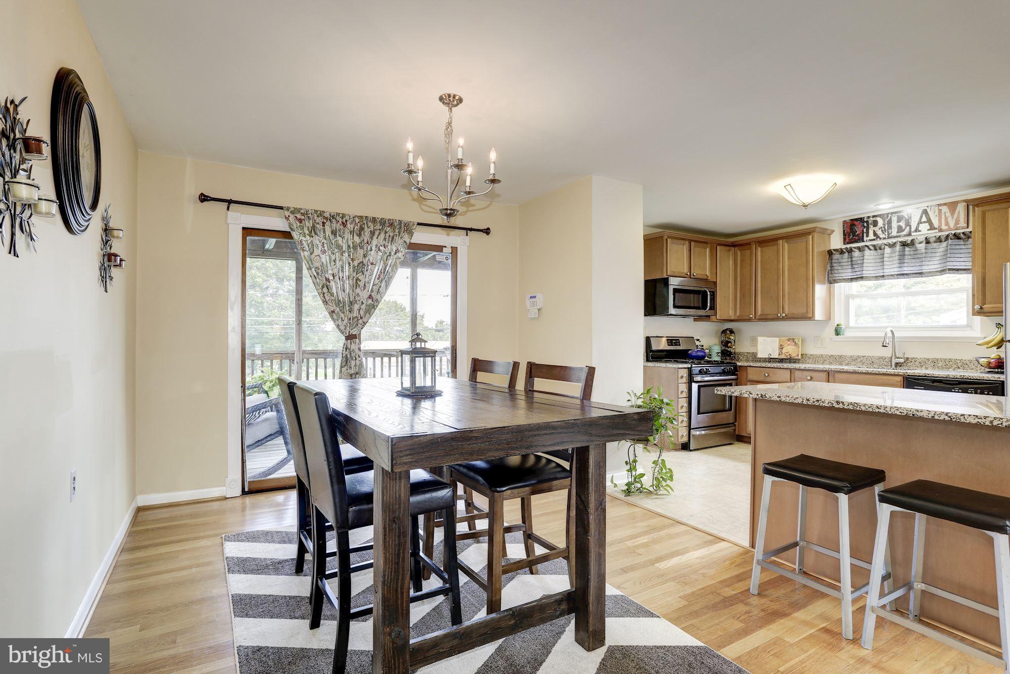 6134 Wheatland Road Baltimore, MD 21228 - Photo 4 of 30 a view of a dining room with furniture window and wooden floor