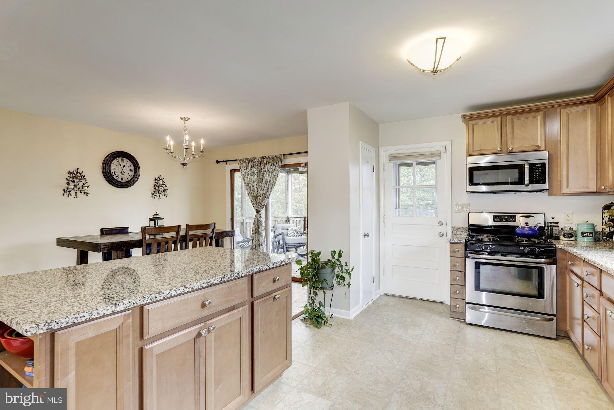 6134 Wheatland Road Baltimore, MD 21228 - Photo 6 of 30 a kitchen with a sink a stove and cabinets