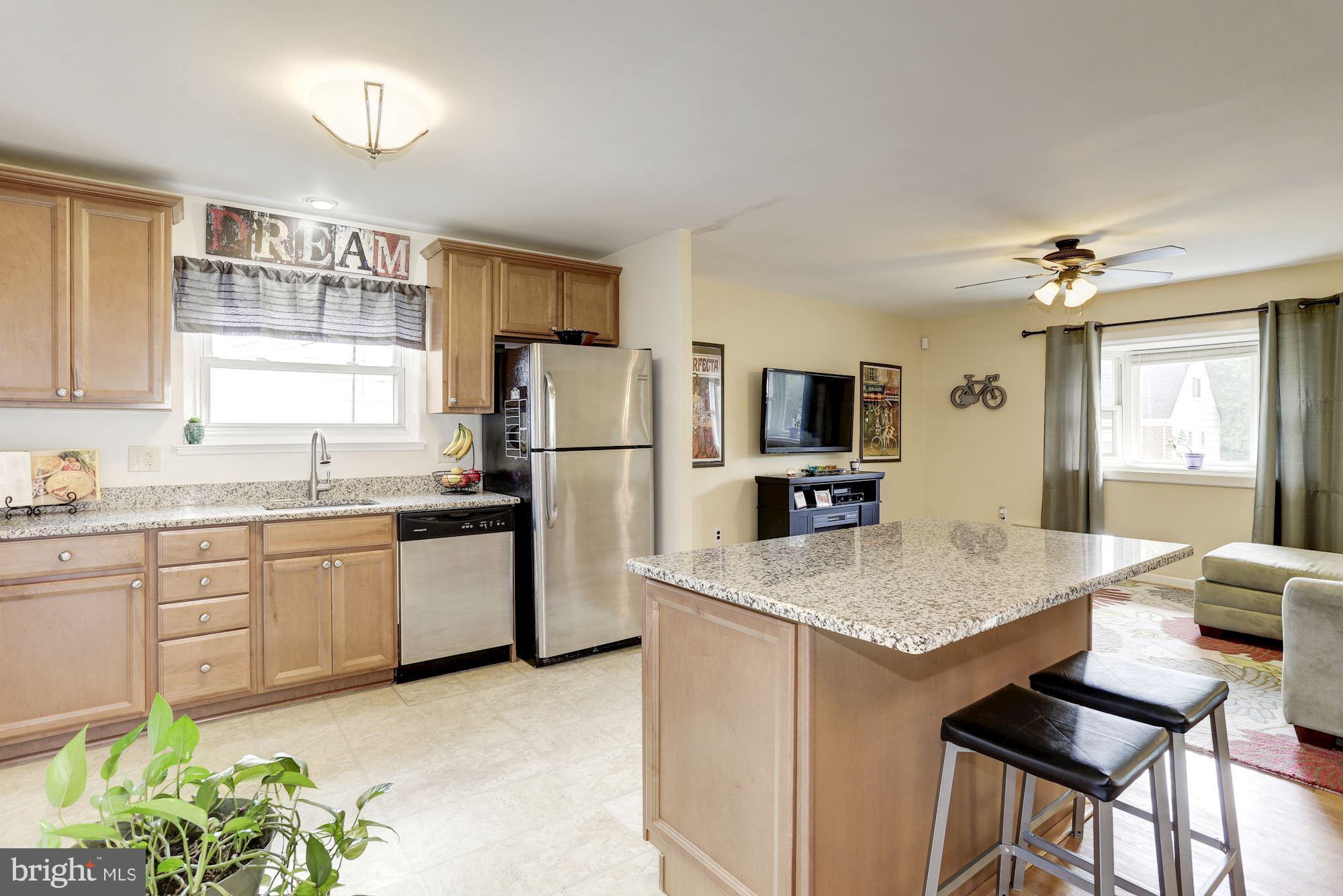 6134 Wheatland Road Baltimore, MD 21228 - Photo 7 of 30 a kitchen with refrigerator cabinets and wooden floor