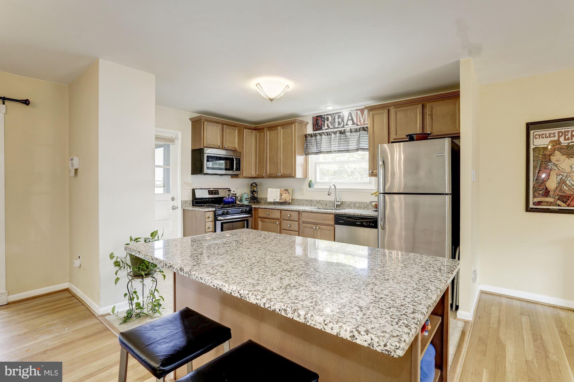 6134 Wheatland Road Baltimore, MD 21228 - Photo 8 of 30 a kitchen with stainless steel appliances granite countertop a refrigerator sink and stove