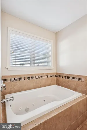 a bathroom with a bathtub and shower