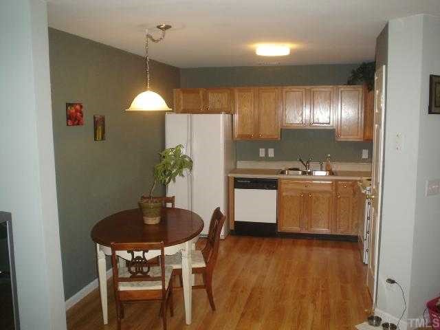 2611 Ivory Run Way, Unit 106 Raleigh, NC 27603 - Photo 2 of 9 a kitchen with a table and chairs in it