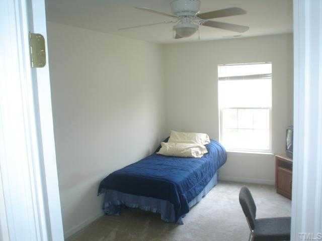 2611 Ivory Run Way, Unit 106 Raleigh, NC 27603 - Photo 4 of 9 a bedroom with a bed and window