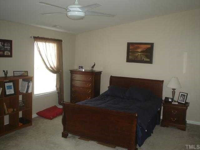 2611 Ivory Run Way, Unit 106 Raleigh, NC 27603 - Photo 6 of 9 a bedroom with a bed and a window