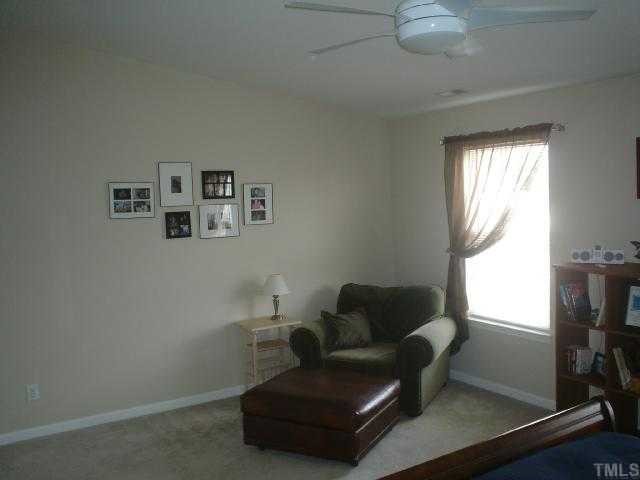 2611 Ivory Run Way, Unit 106 Raleigh, NC 27603 - Photo 7 of 9 a living room with furniture and a window