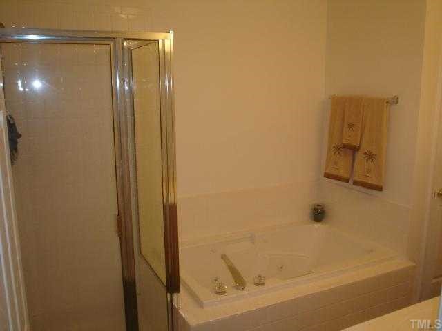 2611 Ivory Run Way, Unit 106 Raleigh, NC 27603 - Photo 8 of 9 a bathroom with a shower and a sink