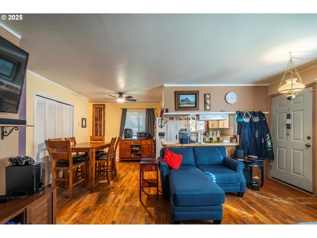 a living room with lots of furniture and kitchen view