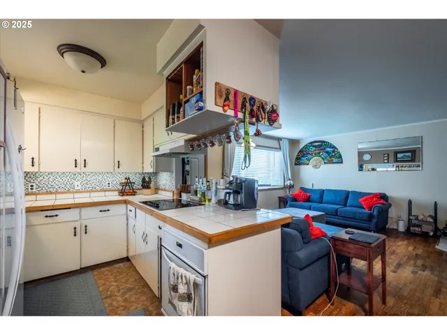 a kitchen that has a sink and a stove in it