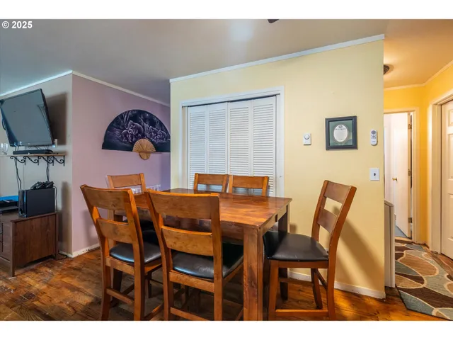 a dining room with furniture and wooden floor