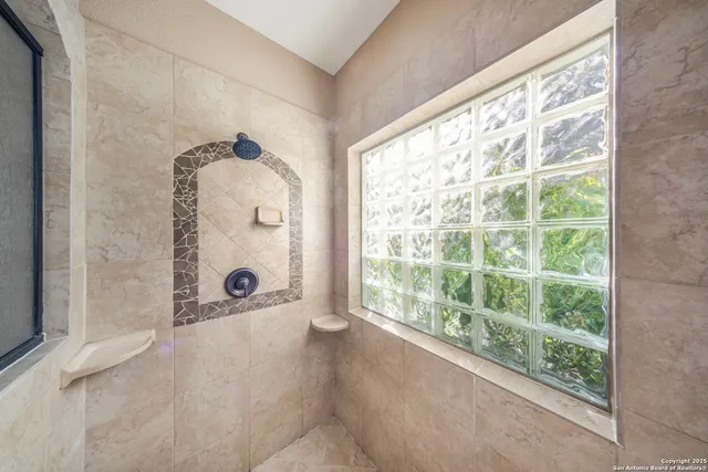 a bathroom with a tub and shower