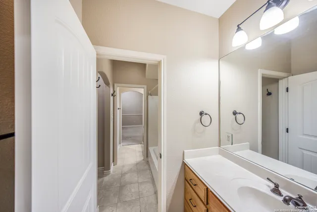 a bathroom with a sink a mirror and a shower