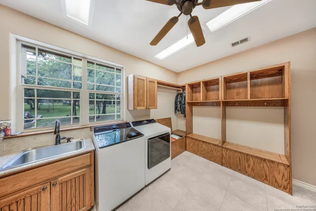 a kitchen with granite countertop a sink and a refrigerator