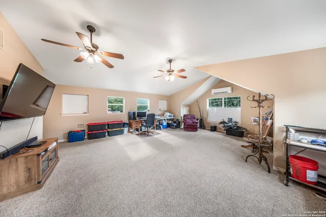 a view of a livingroom with furniture and a ceiling fan