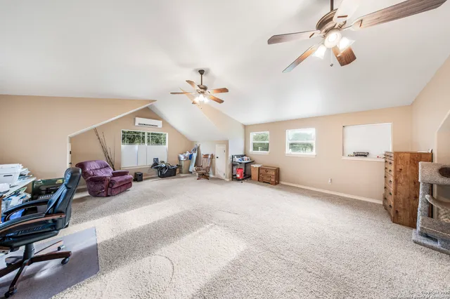 a view of a livingroom with furniture and a ceiling fan