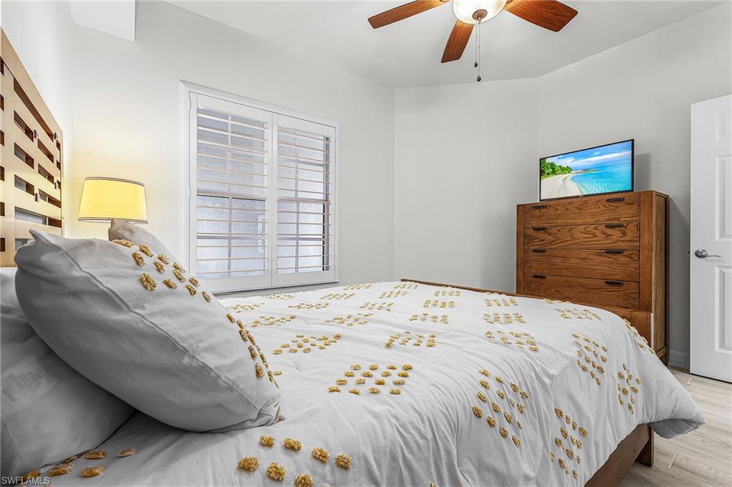 401 Bayfront Place, Unit 3405 Naples, FL 34102 - Photo 13 of 31 a bedroom with a bed and a dresser