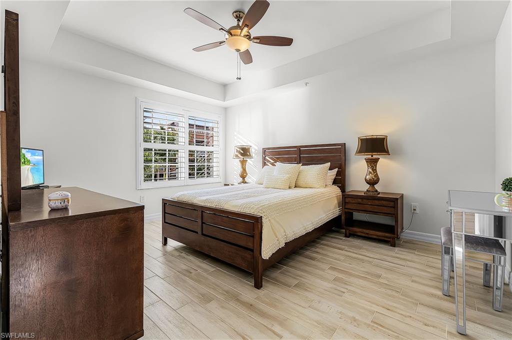 401 Bayfront Place, Unit 3405 Naples, FL 34102 - Photo 16 of 31 a bedroom with a bed and a chandelier