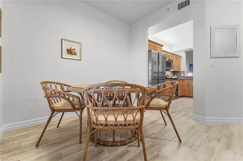 401 Bayfront Place, Unit 3405 Naples, FL 34102 - Photo 5 of 31 a view of a dining room with furniture and wooden floor