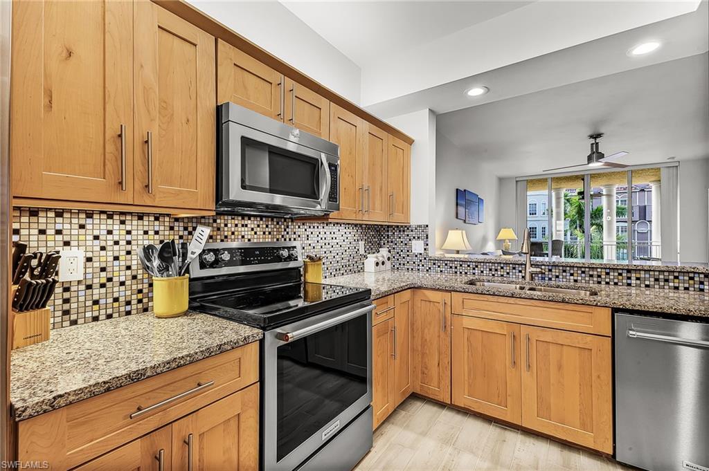 401 Bayfront Place, Unit 3405 Naples, FL 34102 - Photo 7 of 31 a kitchen with granite countertop a sink stove and microwave
