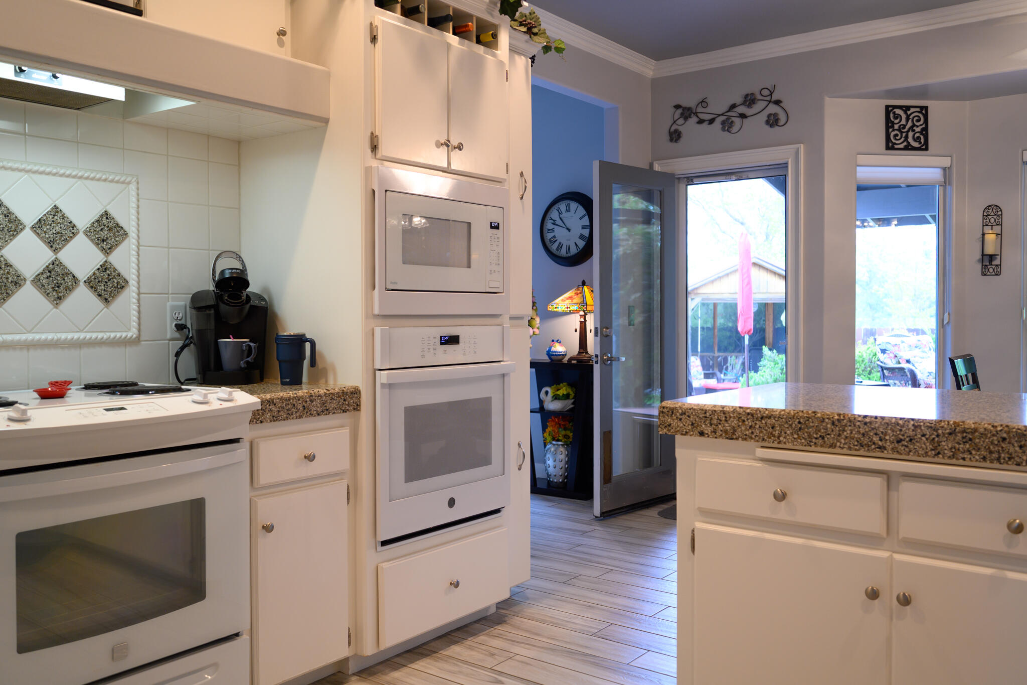 2071 Hope Lane Redding, CA 96003 - Photo 19 of 45 a kitchen with granite countertop cabinets stainless steel appliances and a large window