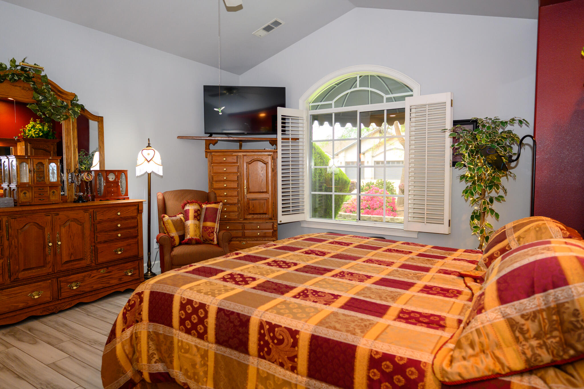 2071 Hope Lane Redding, CA 96003 - Photo 40 of 45 a bedroom with a bed and a flat tv screen on dresser