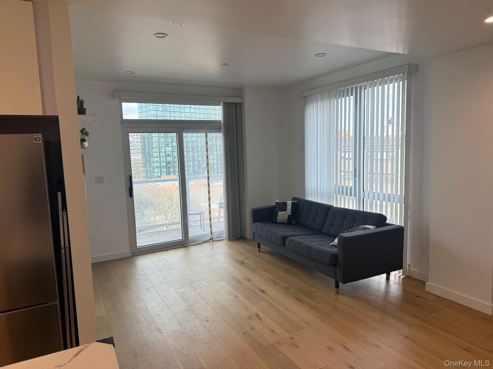 97-29 64th Road Queens, NY 11374 - Photo 2 of 12 a living room with furniture and a window