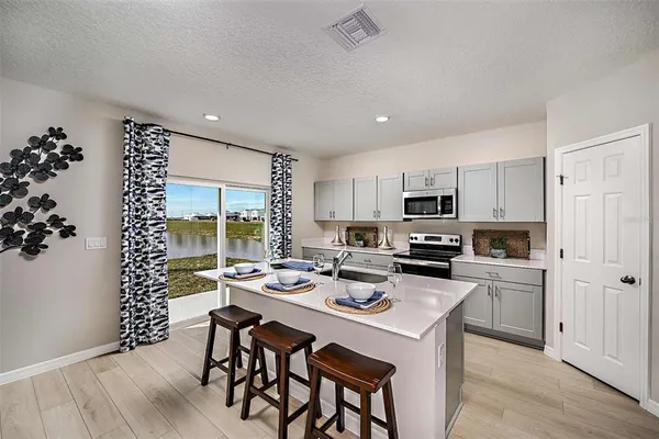 a kitchen with a table and chairs in it