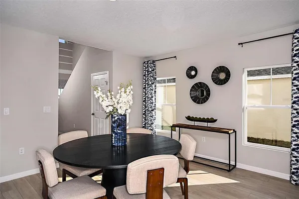 a dining room with furniture and wooden floor