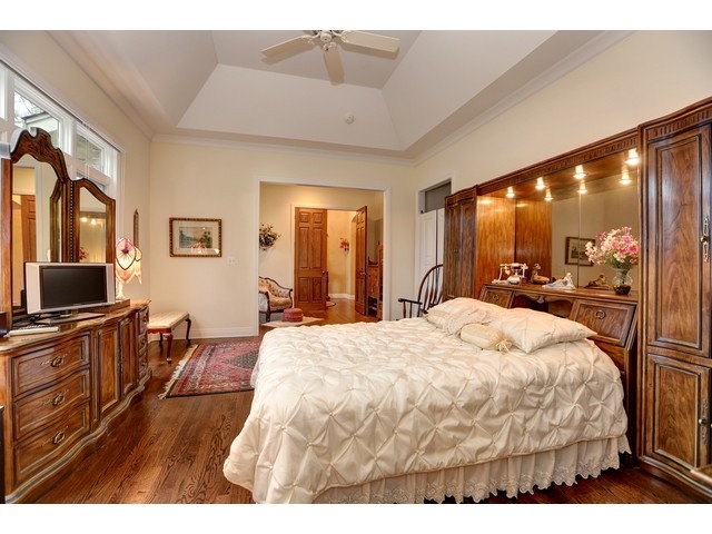 6350 Clarendon Hills Road Willowbrook, IL 60527 - Photo 13 of 25 a large bedroom with a bed and a flat tv screen on dresser