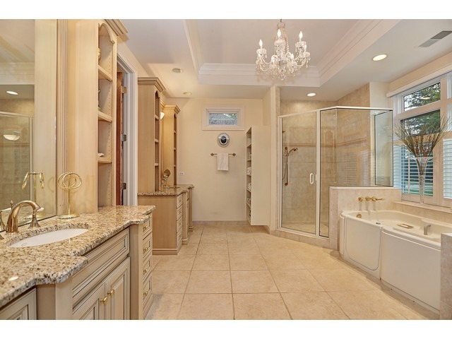 6350 Clarendon Hills Road Willowbrook, IL 60527 - Photo 14 of 25 a bathroom with a granite countertop sink a large mirror and a shower