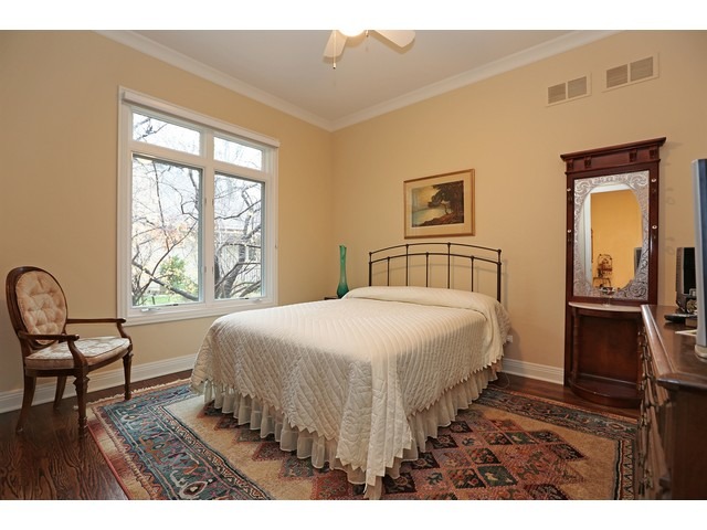 6350 Clarendon Hills Road Willowbrook, IL 60527 - Photo 17 of 25 a bedroom with a bed and wooden floor