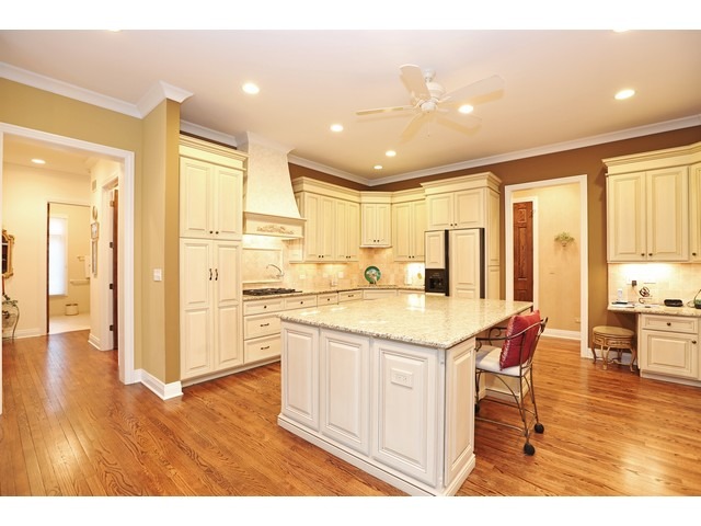 6350 Clarendon Hills Road Willowbrook, IL 60527 - Photo 5 of 25 a kitchen with stainless steel appliances granite countertop a refrigerator a stove and white cabinets with wooden floor
