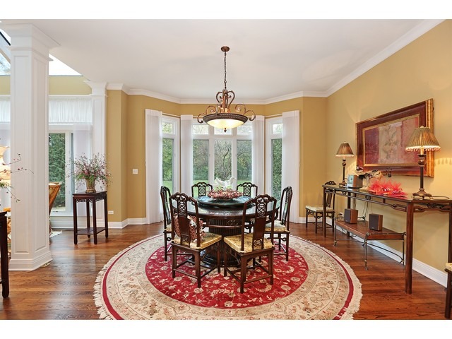 6350 Clarendon Hills Road Willowbrook, IL 60527 - Photo 8 of 25 a living room with furniture a large window and a dining table