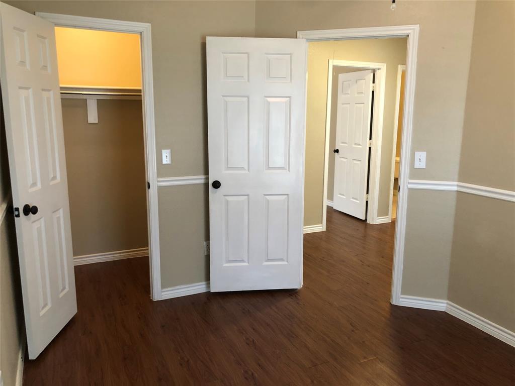 8301 Bells Street Frisco, TX 75035 - Photo 18 of 24 an empty room with wooden floor and closet