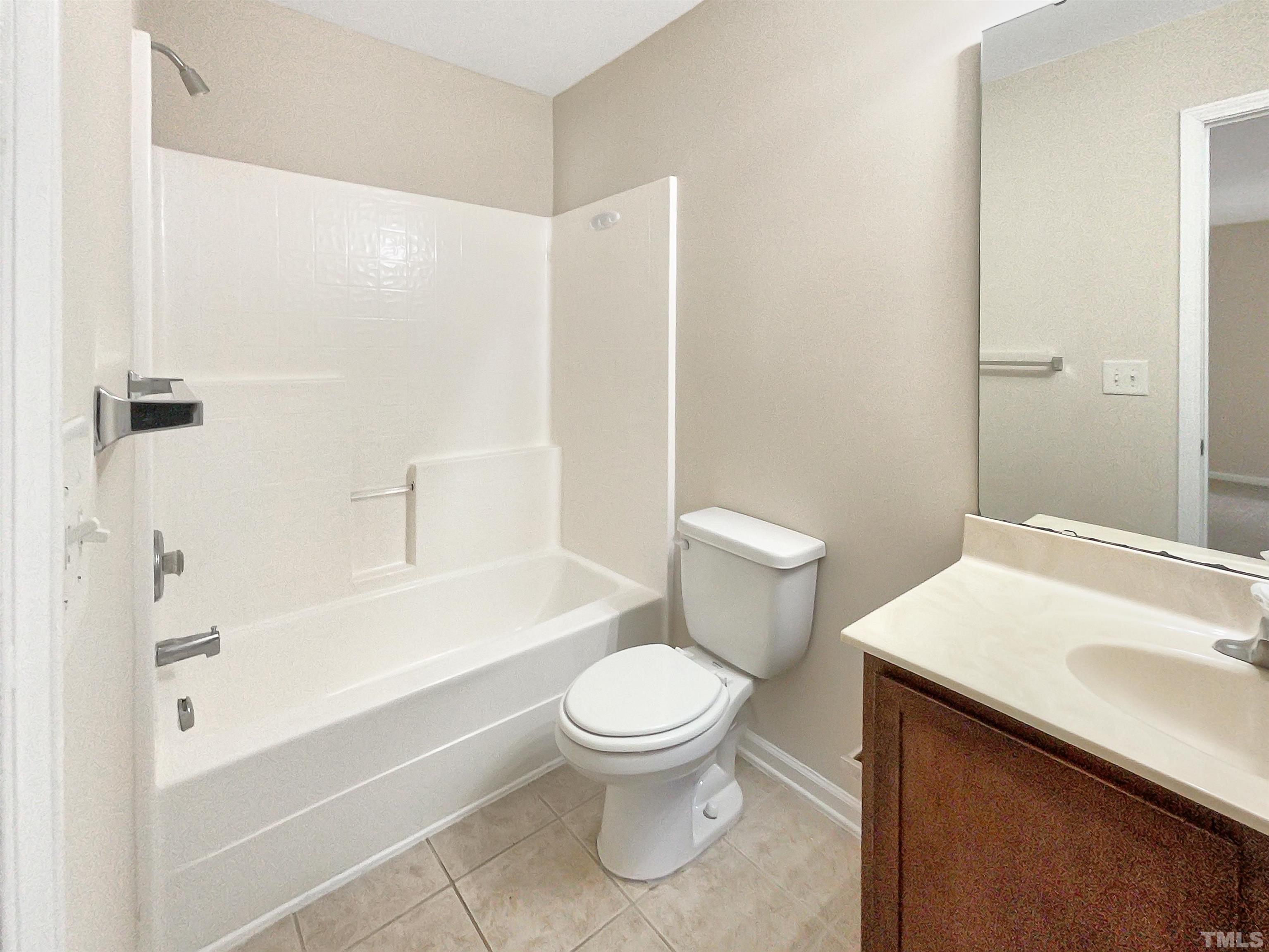 3501 Pinkham Way Raleigh, NC 27616 - Photo 12 of 20 a bathroom with a sink a toilet and a bathtub