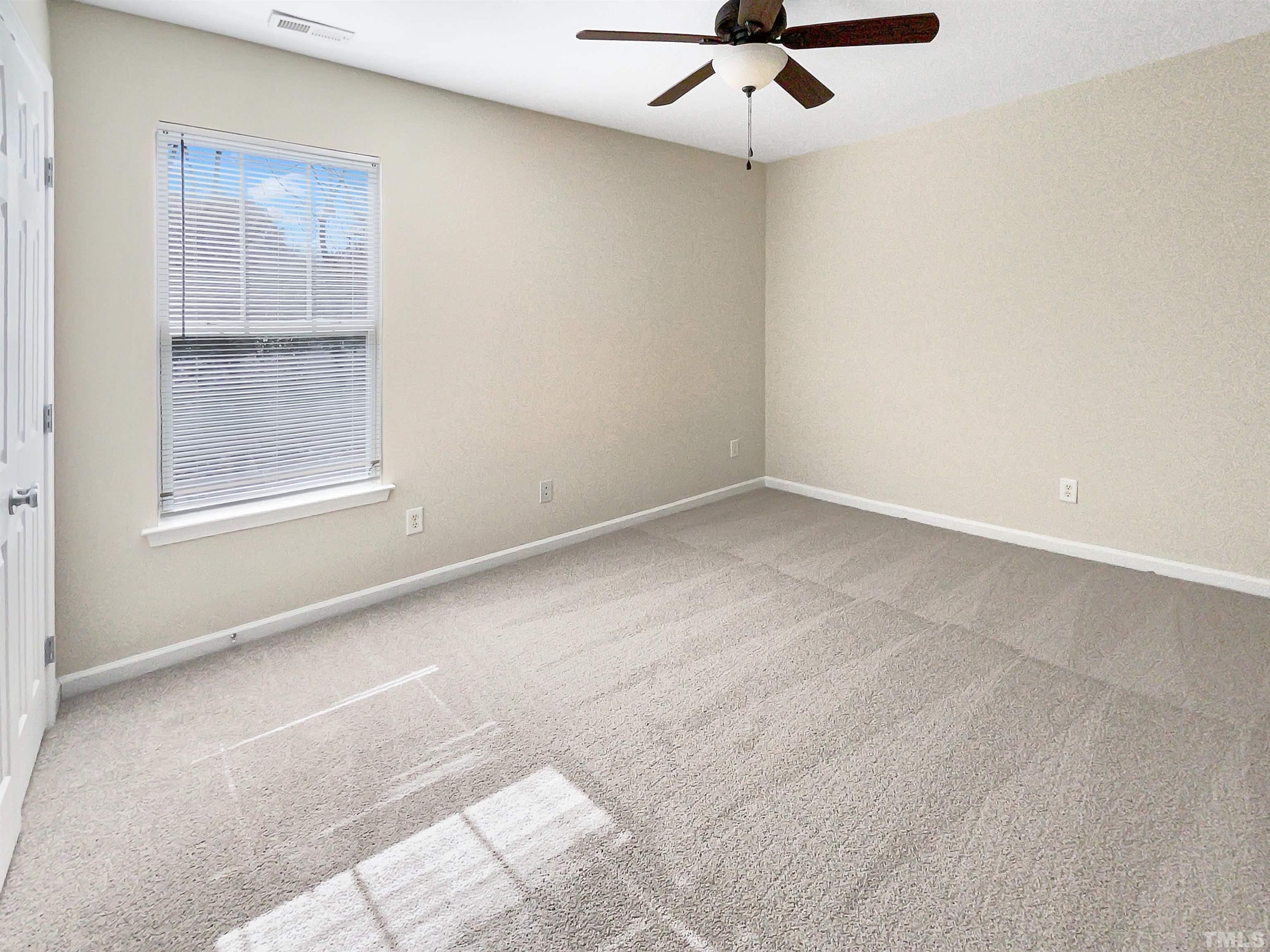 3501 Pinkham Way Raleigh, NC 27616 - Photo 15 of 20 an empty room with a window and a ceiling fan