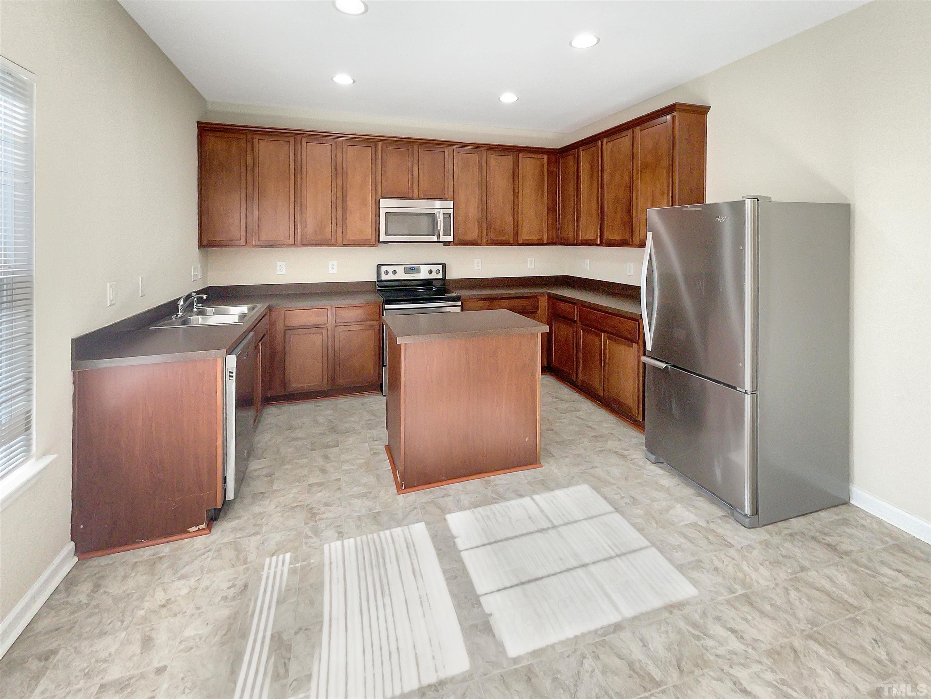 3501 Pinkham Way Raleigh, NC 27616 - Photo 2 of 20 a kitchen with stainless steel appliances granite countertop a refrigerator sink and cabinets