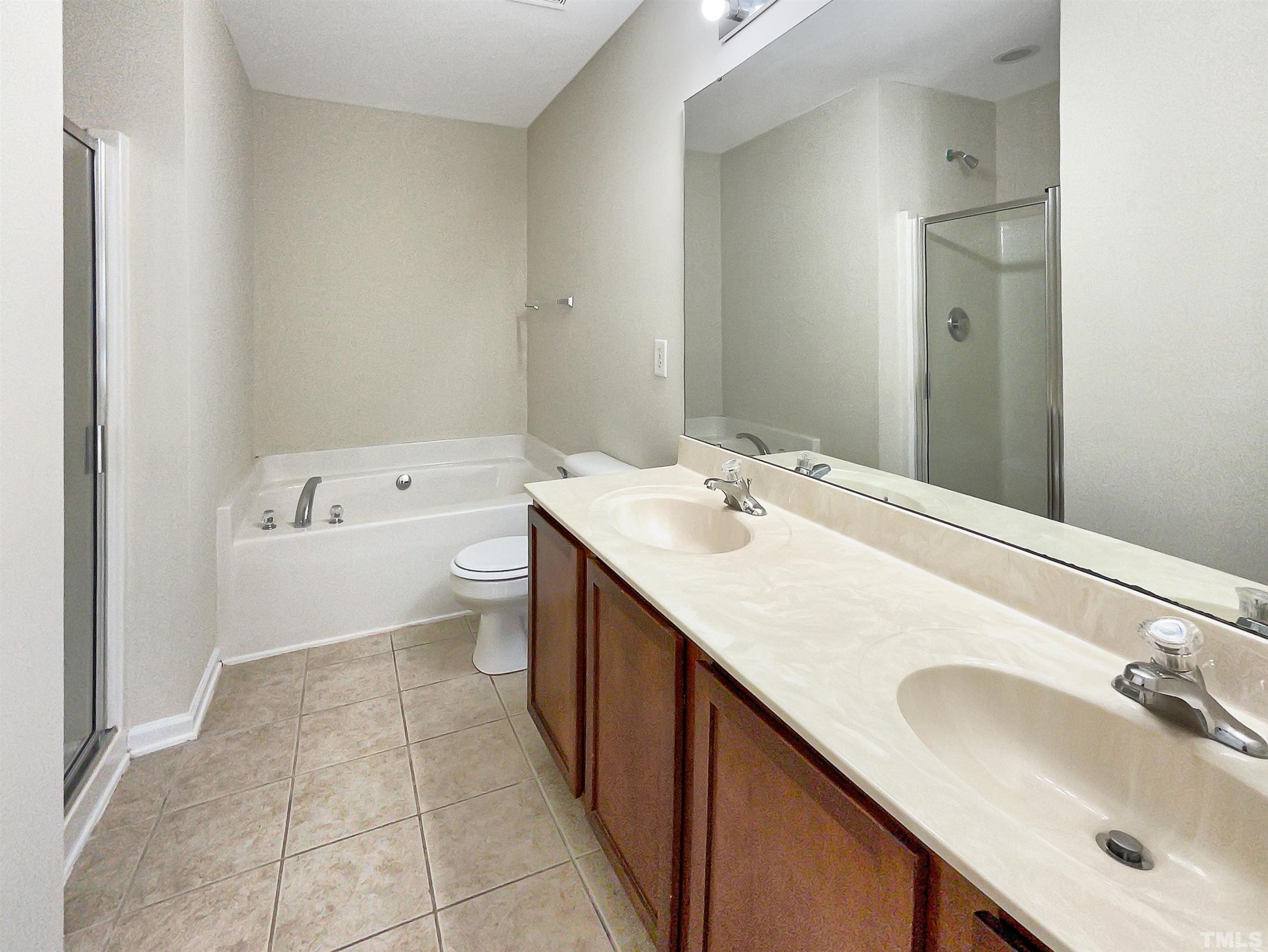 3501 Pinkham Way Raleigh, NC 27616 - Photo 3 of 20 a bathroom with a sink a toilet and a mirror
