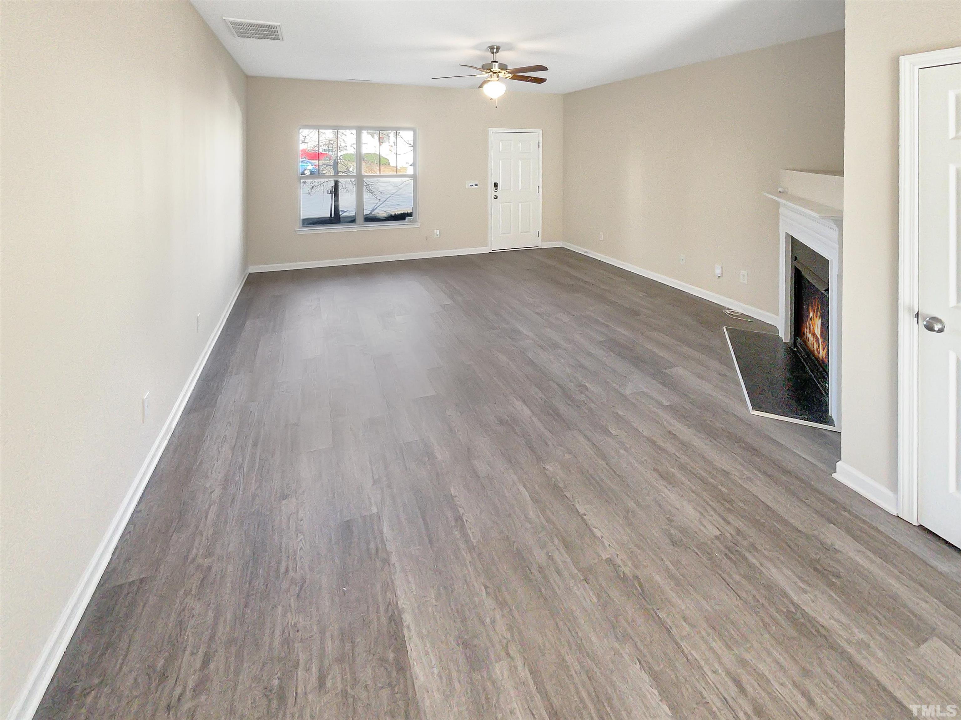 3501 Pinkham Way Raleigh, NC 27616 - Photo 4 of 20 an empty room with wooden floor and windows