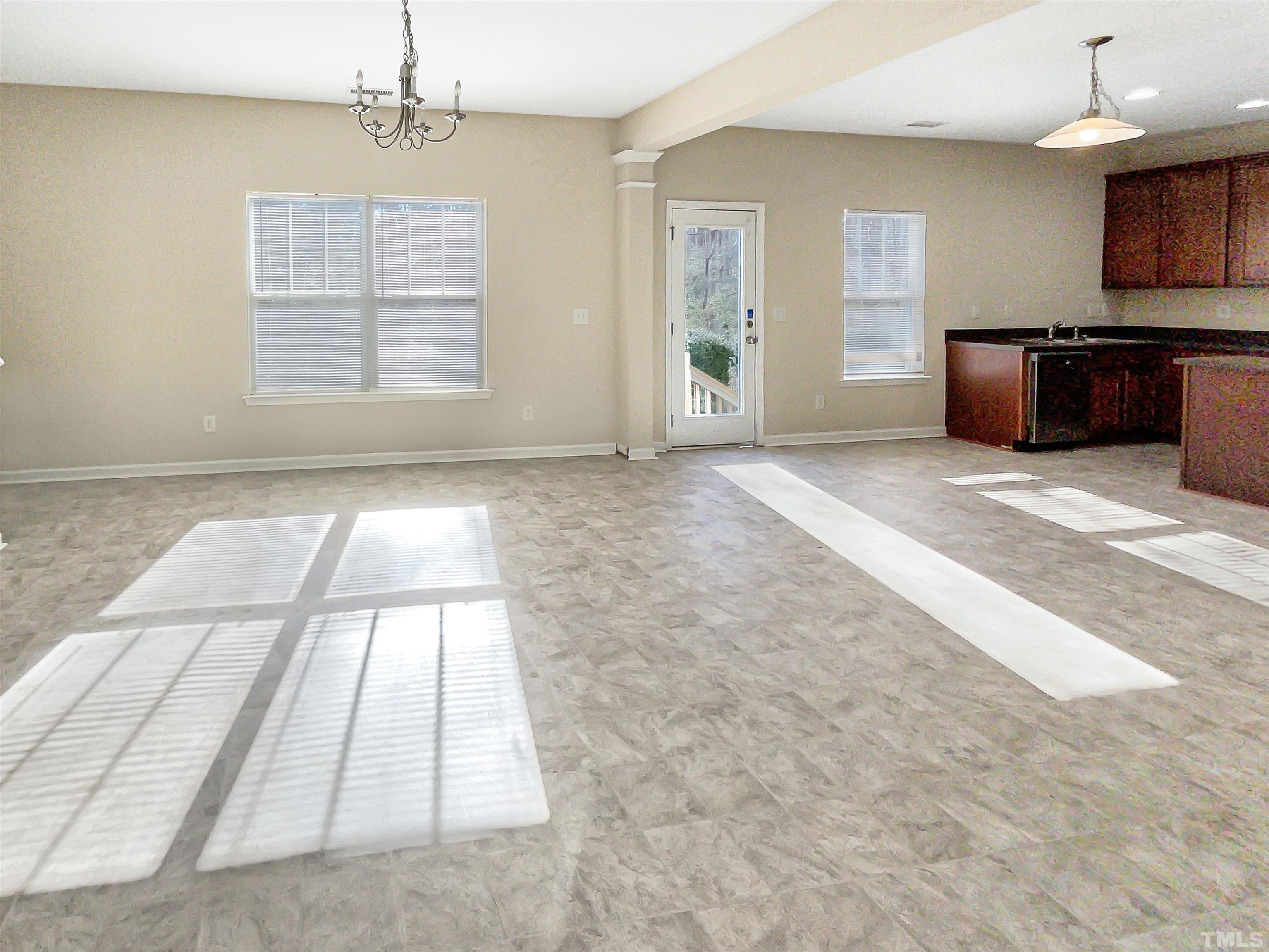 3501 Pinkham Way Raleigh, NC 27616 - Photo 6 of 20 a view of an empty room with a kitchen