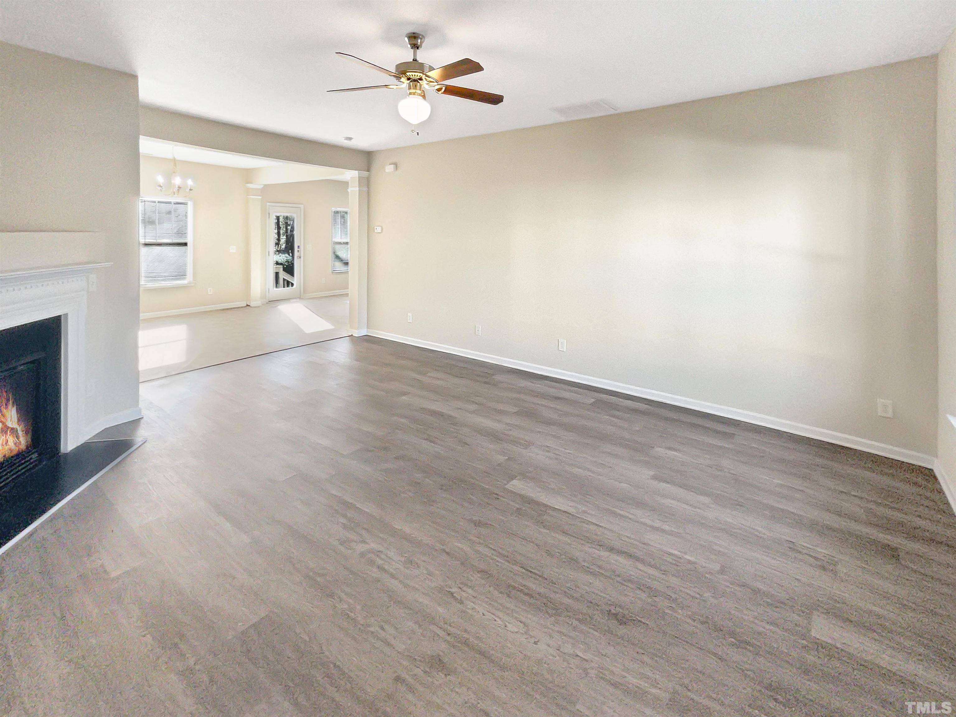 3501 Pinkham Way Raleigh, NC 27616 - Photo 7 of 20 a view of empty room with wooden floor and fireplace