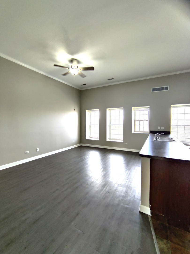 2026 North 3372nd Road, Unit 503 Ottawa, IL 61350 - Photo 17 of 49 an empty room with wooden floor and windows