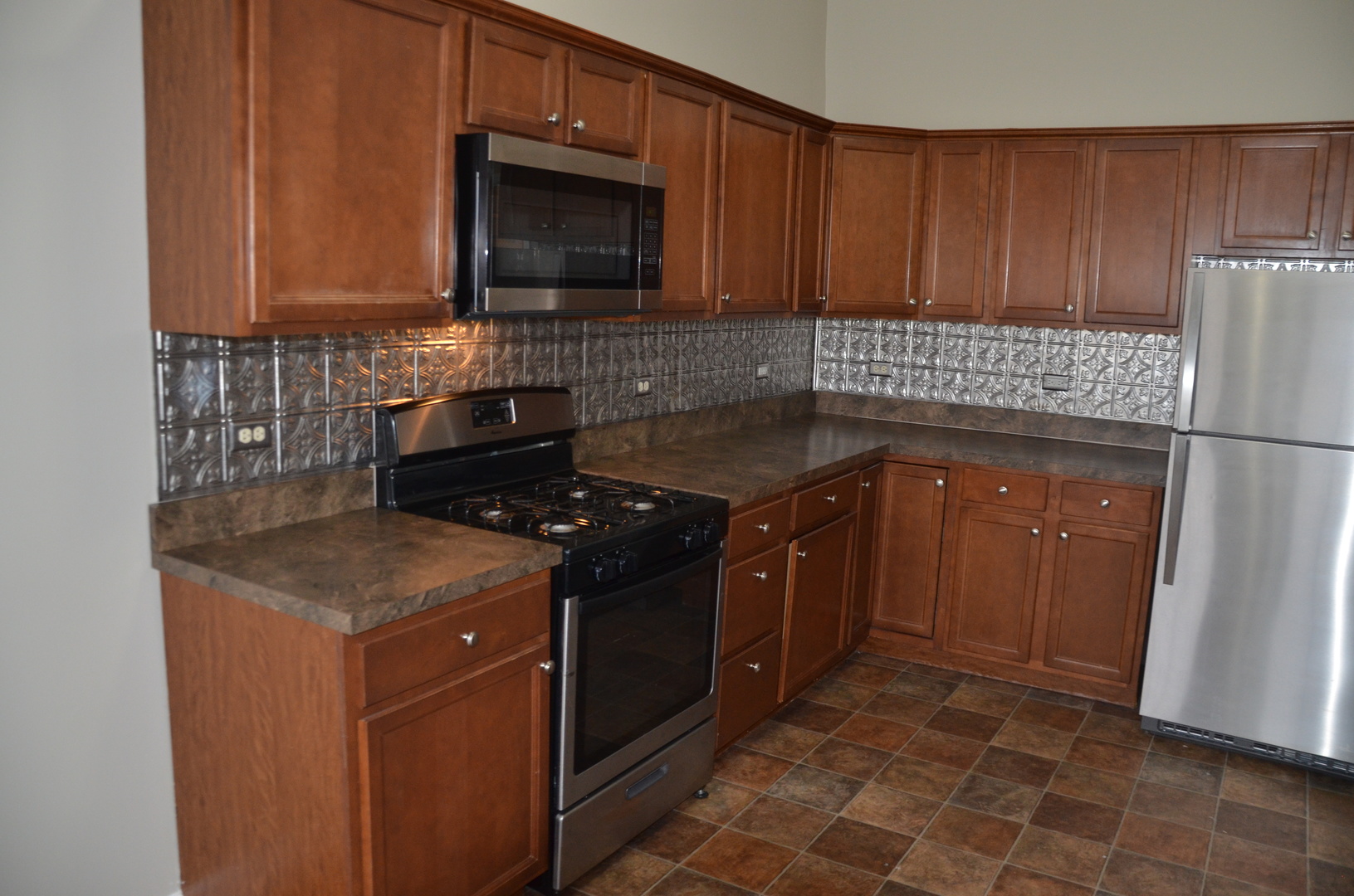 2026 North 3372nd Road, Unit 503 Ottawa, IL 61350 - Photo 24 of 49 a kitchen with granite countertop wooden cabinets and a stove top oven