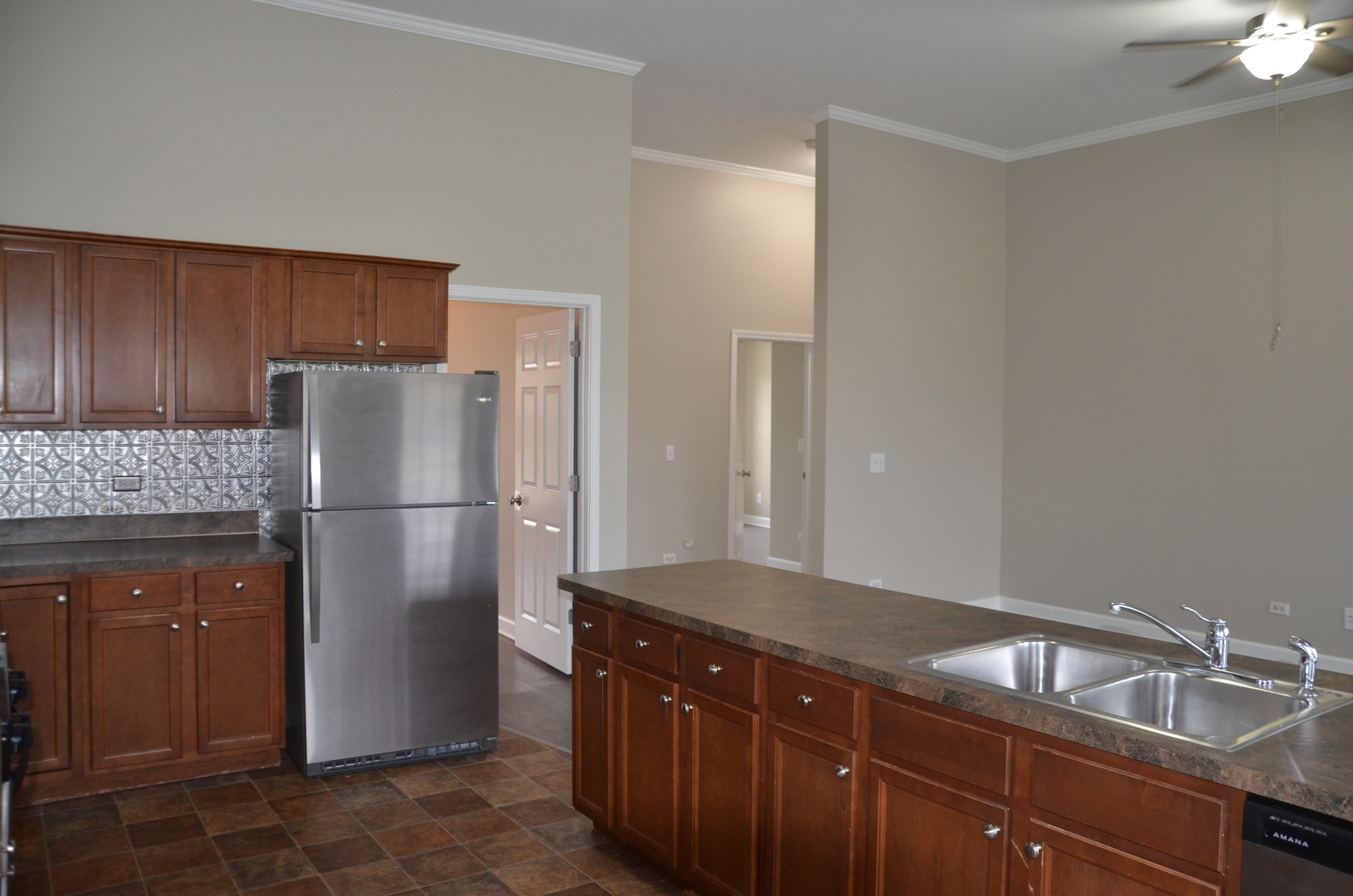 2026 North 3372nd Road, Unit 503 Ottawa, IL 61350 - Photo 27 of 49 a kitchen with a sink a refrigerator and cabinets