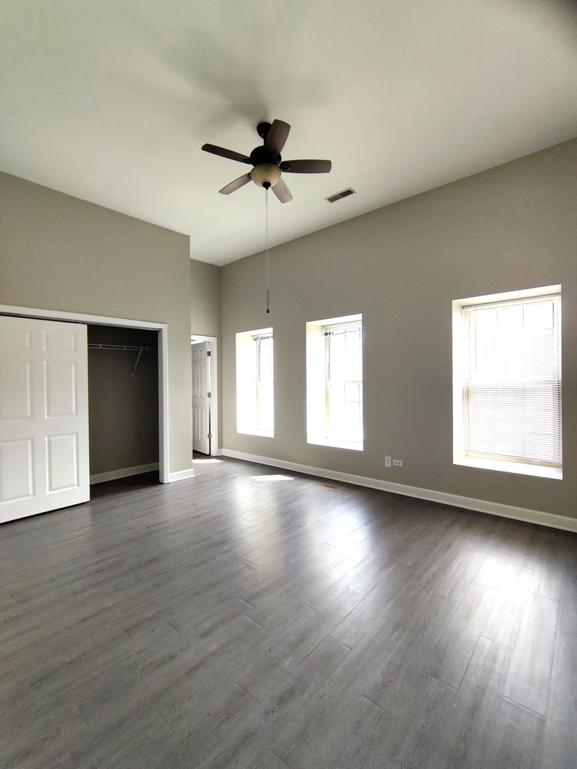 2026 North 3372nd Road, Unit 503 Ottawa, IL 61350 - Photo 4 of 49 a view of an empty room with wooden floor and a window