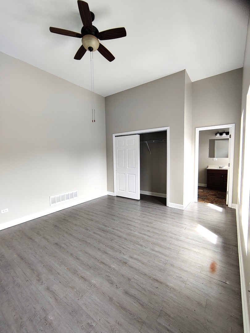2026 North 3372nd Road, Unit 503 Ottawa, IL 61350 - Photo 5 of 49 a view of a livingroom with wooden floor a ceiling fan and windows