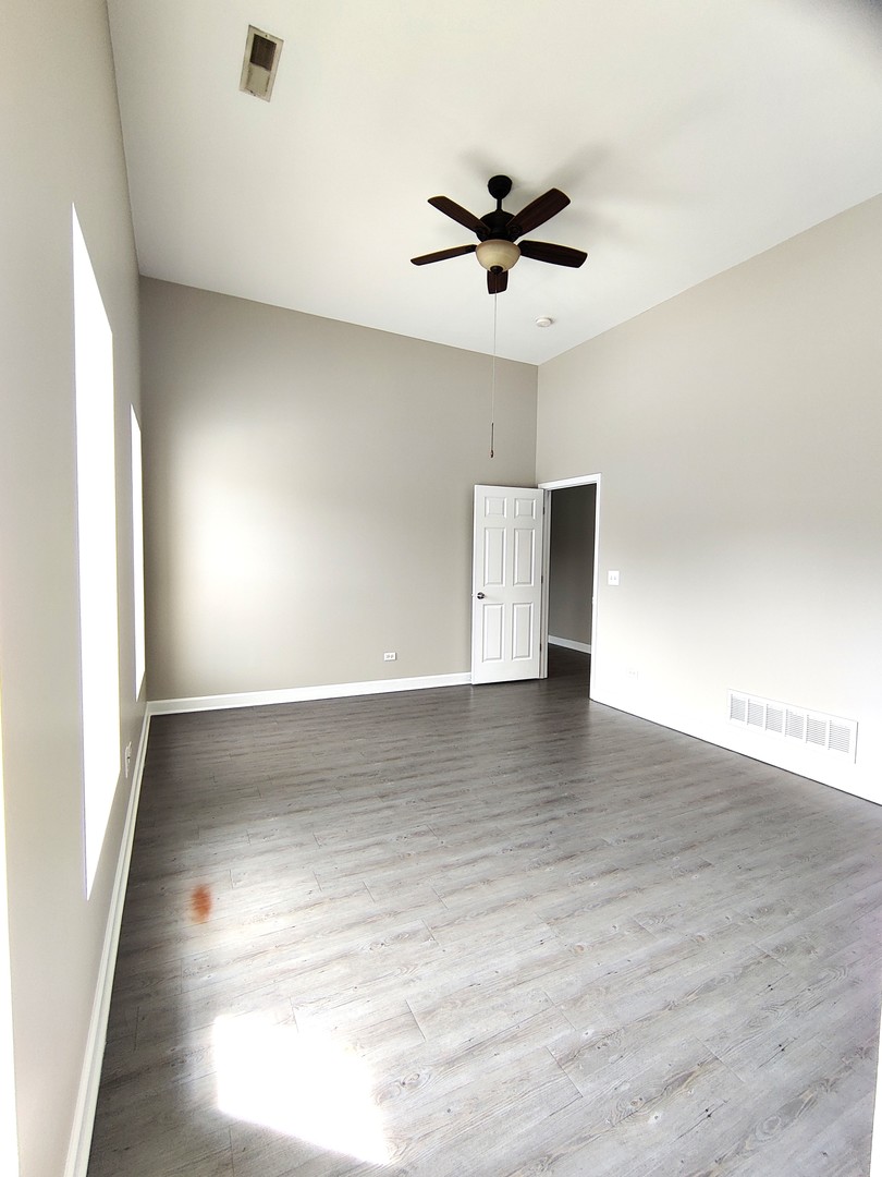 2026 North 3372nd Road, Unit 503 Ottawa, IL 61350 - Photo 7 of 49 an empty room with wooden floor and windows