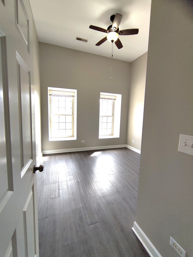 2026 North 3372nd Road, Unit 503 Ottawa, IL 61350 - Photo 9 of 49 a view of an empty room with a window and wooden floor